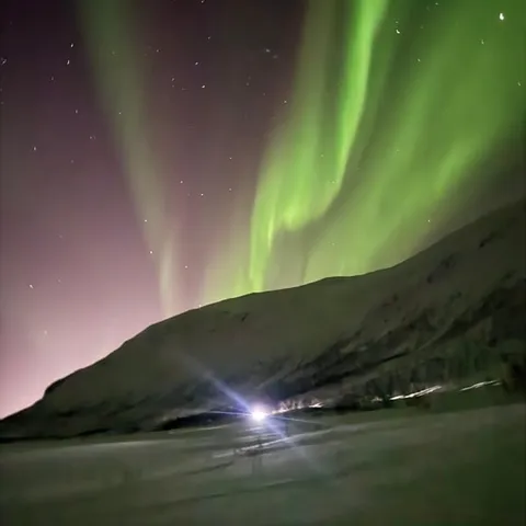 Northern lights above a fjord near Tromsø