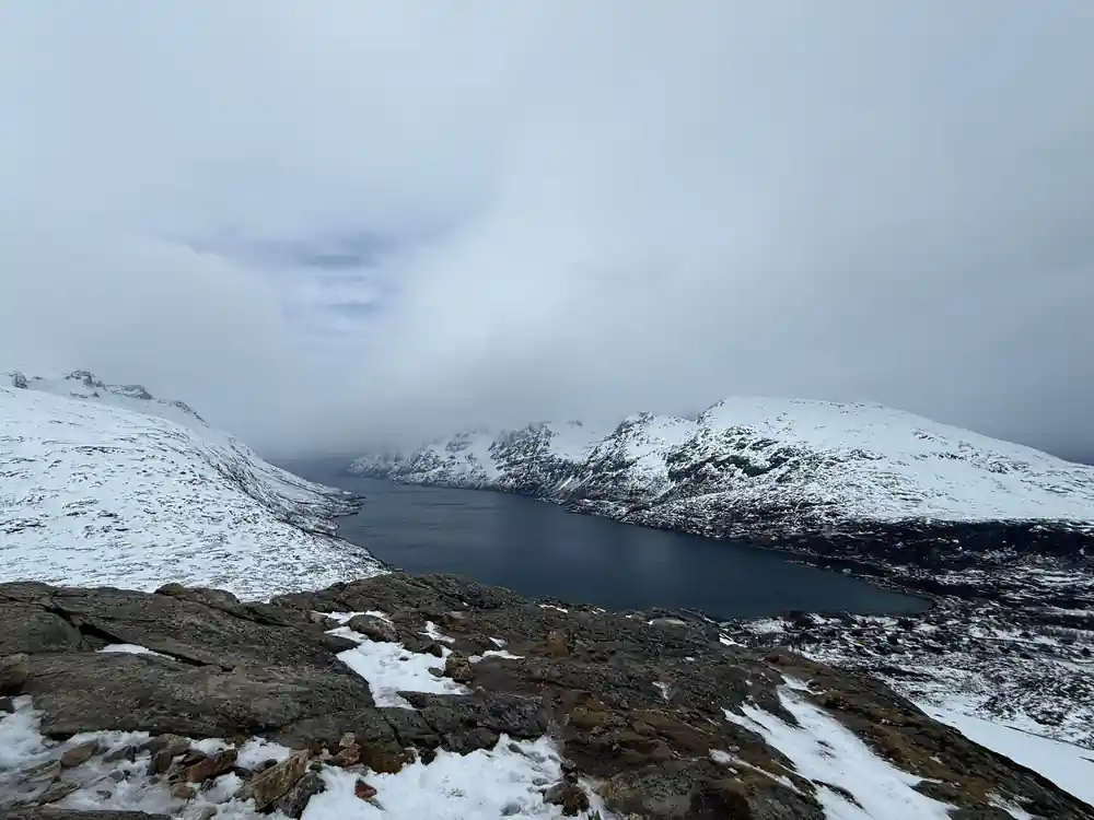 Dark water between snow-covered headlands