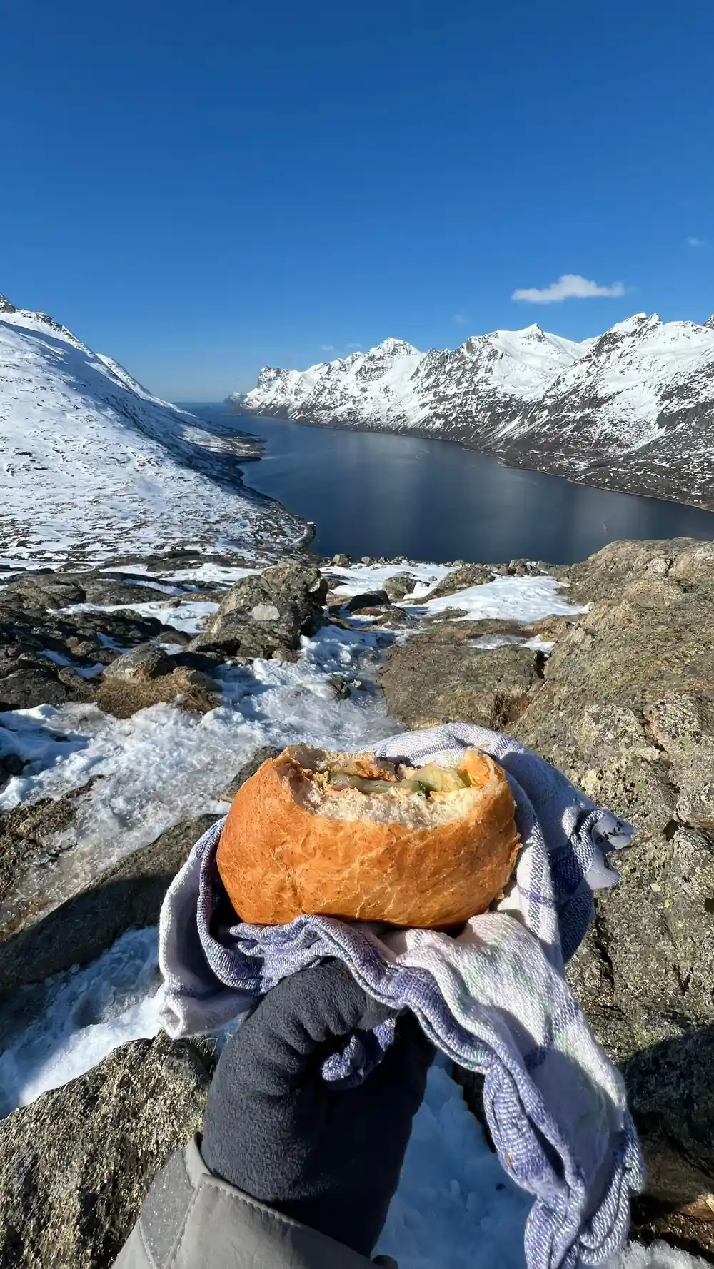 A filled roll on a cloth with the fjord behind