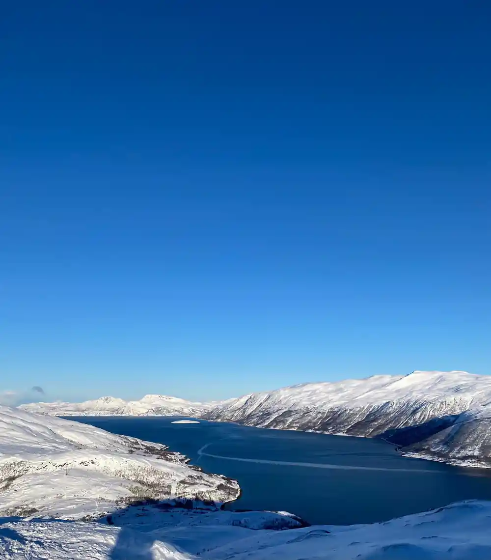 The fjord running away between white ridges