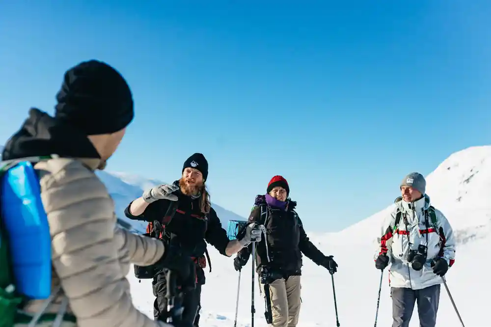 The guide talking to the group out on the snow
