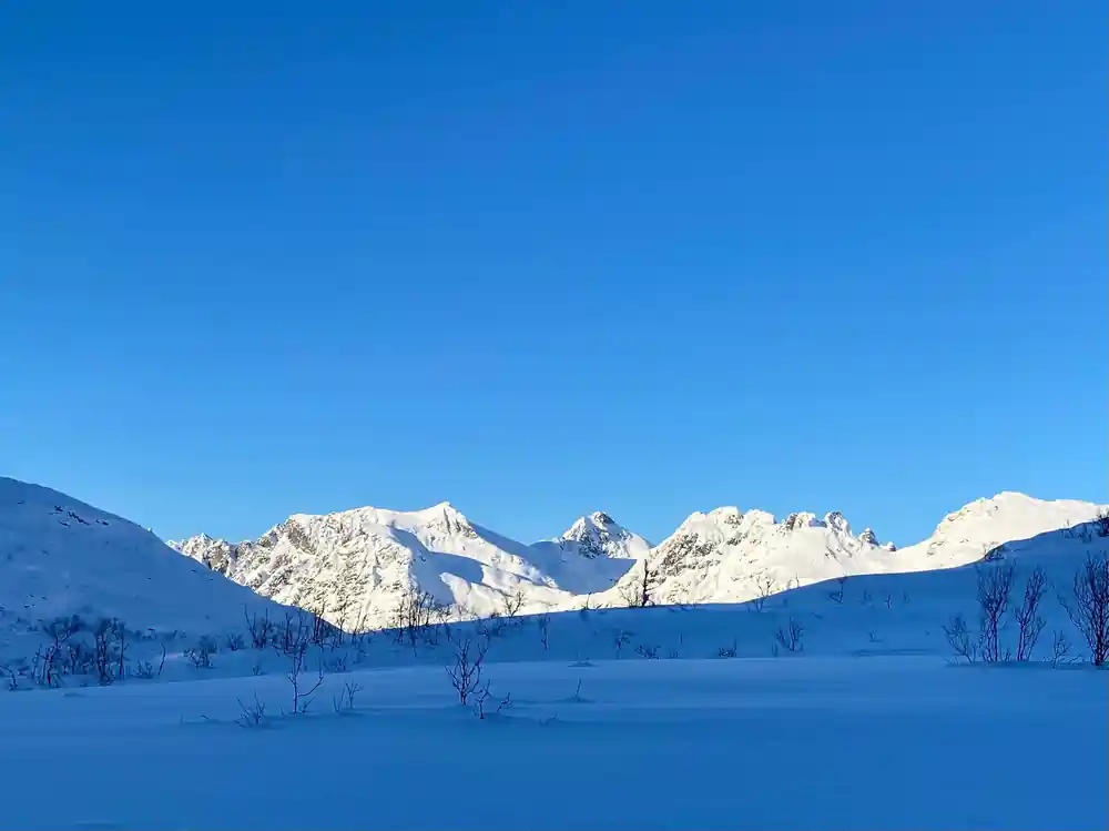Snow peaks above a wide white plain