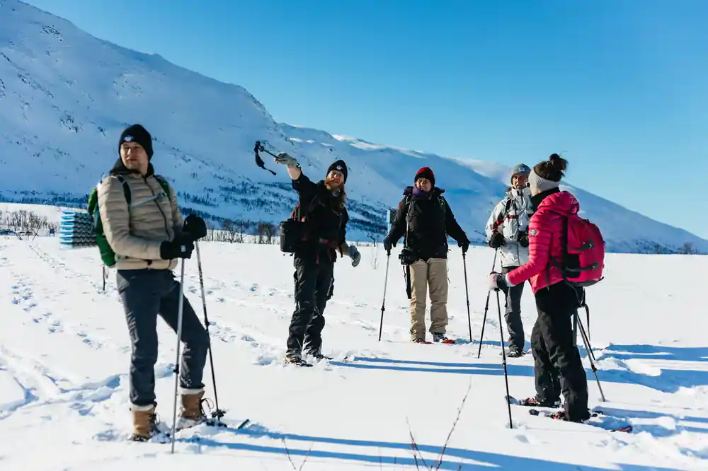 Snowshoers stopped in a group on the open snow
