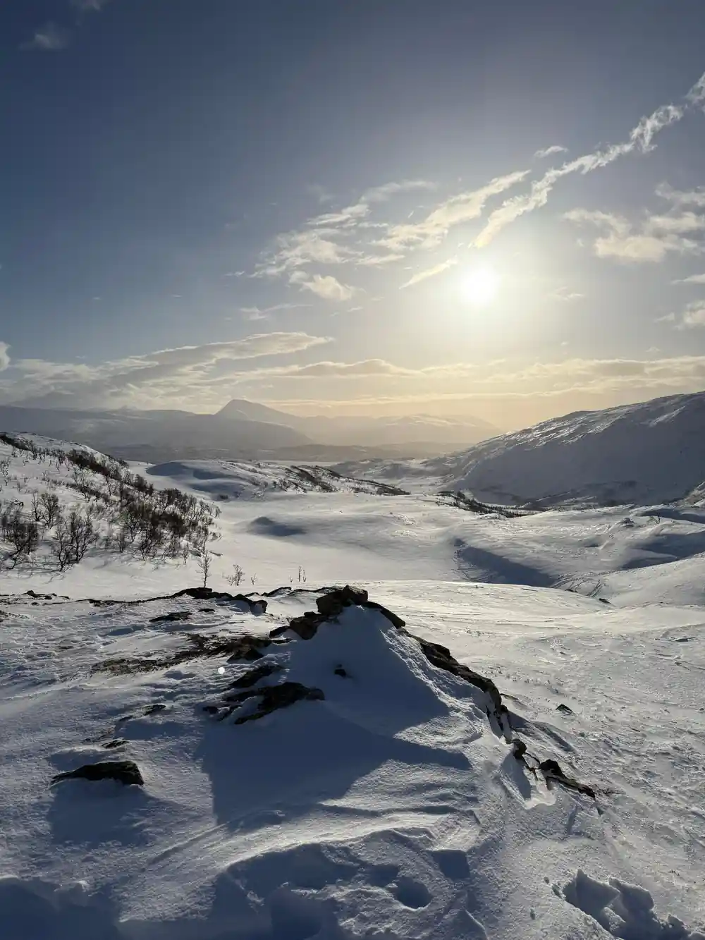 The sun over the snow ridges at midday