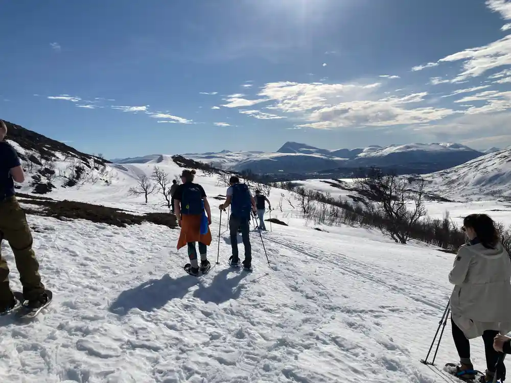 Two snowshoers walking the ridge line