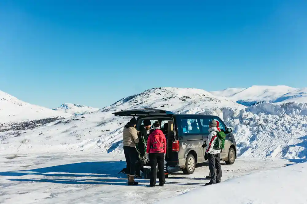 The van at the trailhead with the group gathering