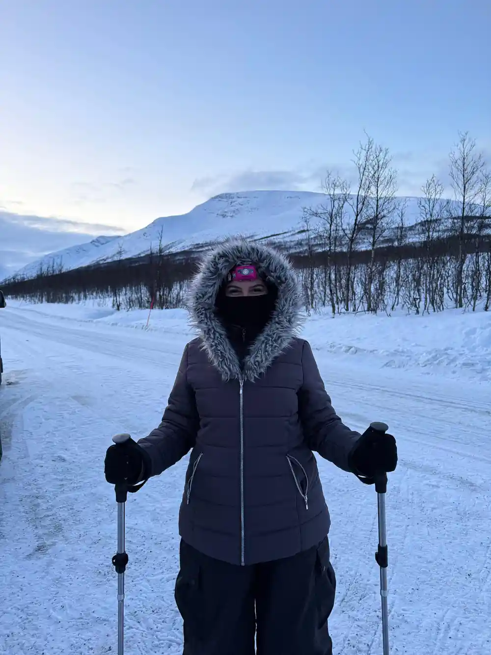 A walker muffled against the cold on the snow track